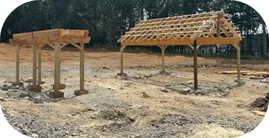 A cedar pergola frame going up on graded ground