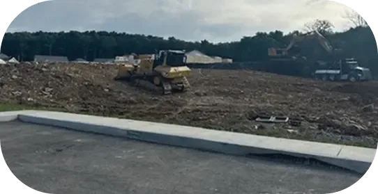 An excavator grading a building lot