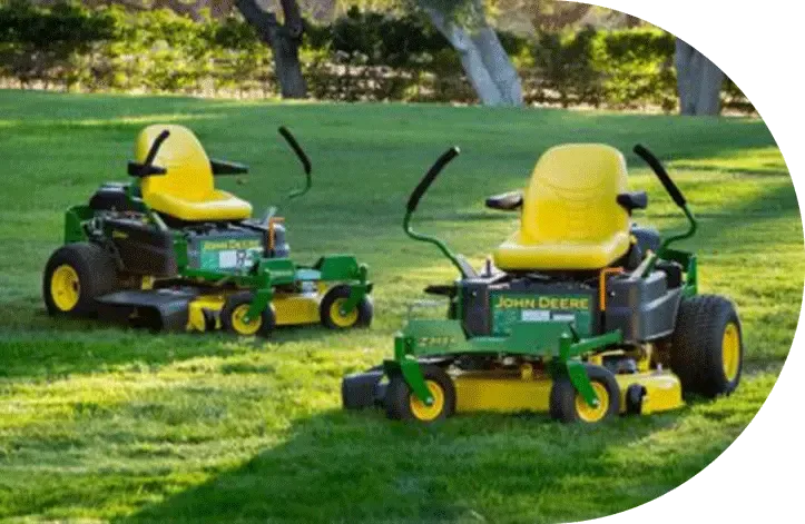 Two zero-turn mowers on a freshly cut lawn